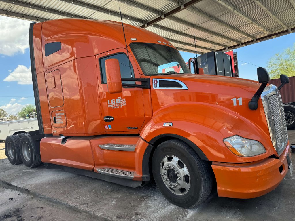 Orange semi truck at repair shop