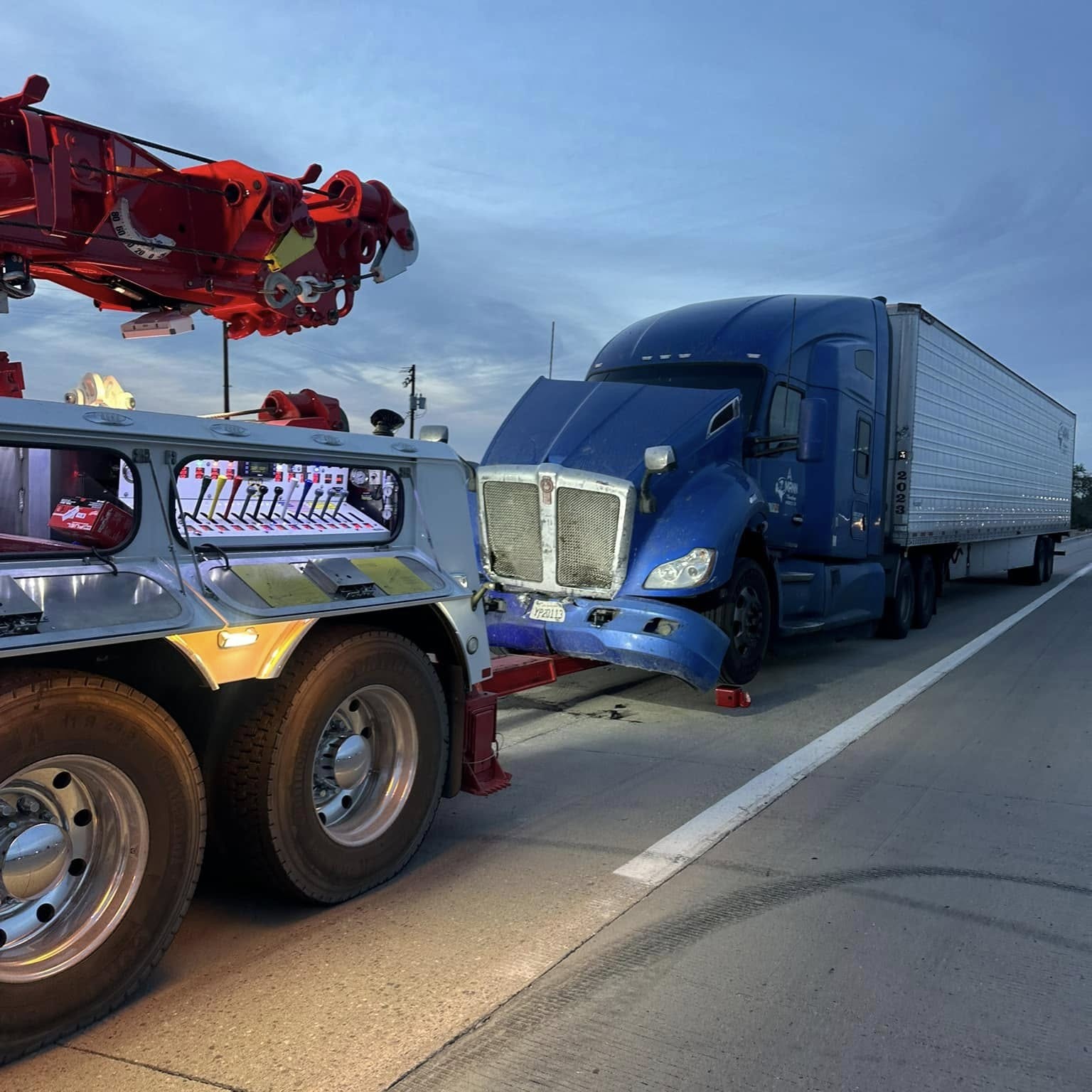 a truck with a broken bumper on the side of the road