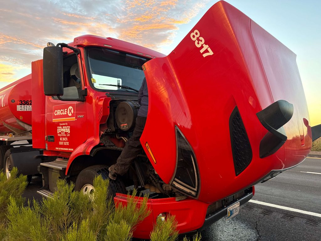 red semi truck broken down on highway